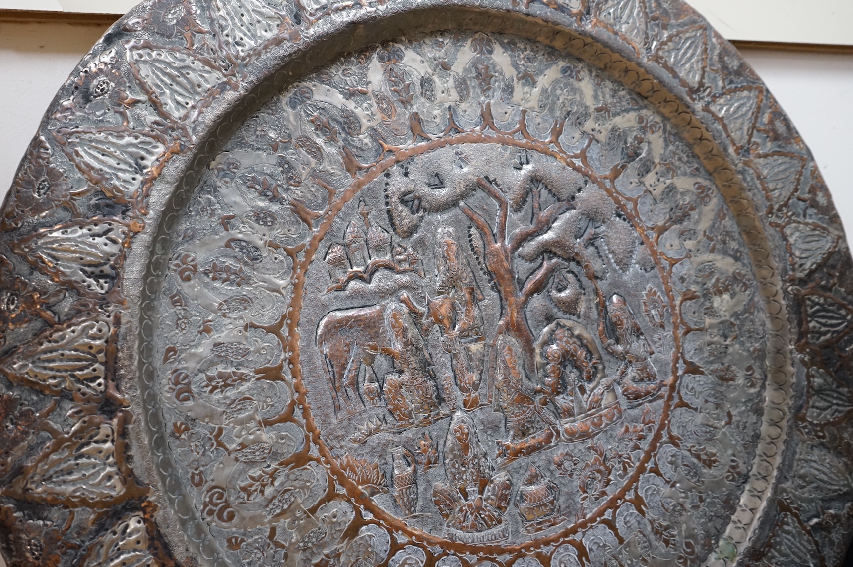 A circular Persian tinned copper embossed tray 88cm diameter